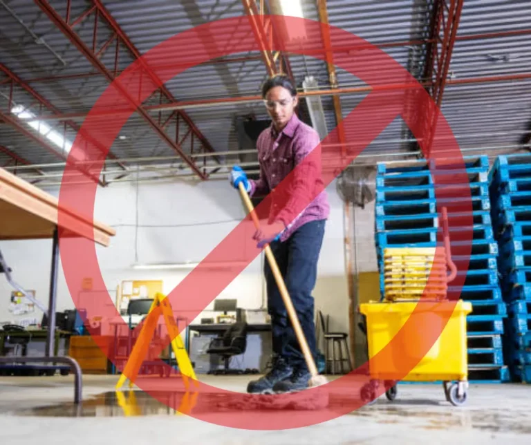 PowerKleen warehouse cleaning graphic showing manual mopping on a wet industrial floor crossed out with a red prohibition symbol.